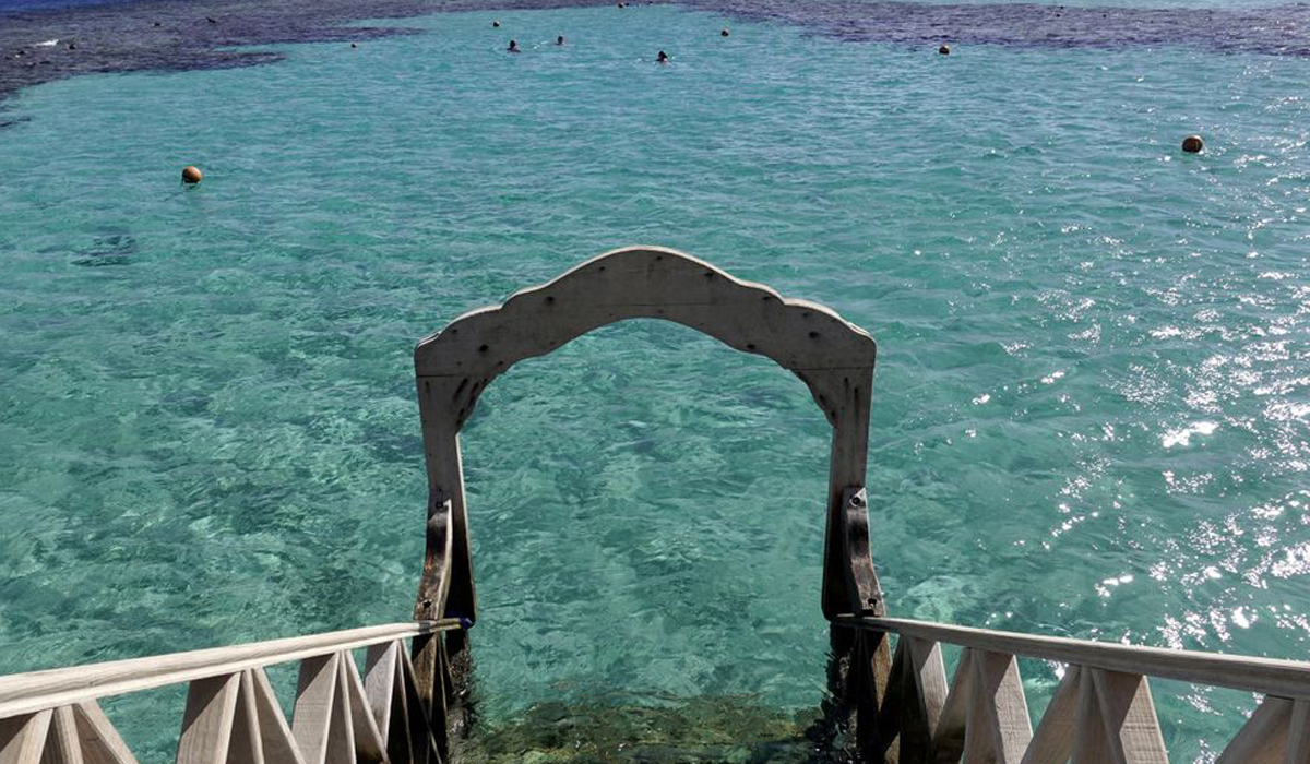 Tourists snorkel near a beach of the Red Sea resort